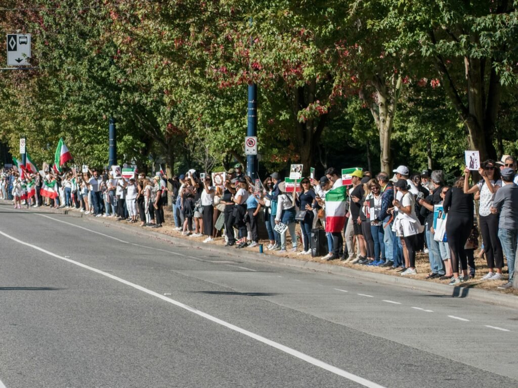 BREAKING: Britain Decides ‘Why Be Fast When You Can Be the Slowest?’—Unveils Europe’s LONGEST Immigration Queue 7 a large group of people marching on the street