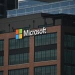A tall building with a microsoft logo on top of it